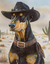 Load image into Gallery viewer, Desert Ranger Western Doberman artwork by Ian Russell, featuring a cowboy-themed Doberman wearing a black hat, leather collar, and holster in a desert landscape with cacti, available at Ian Russell Gallery