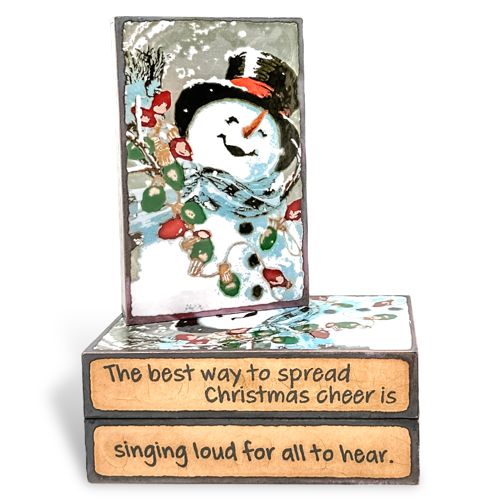 Houston Llew Spiritile #290 ‘Frosty’ – Glass-on-copper art tile featuring a snowman with a red scarf, perfect for holiday decor and collector gifts.