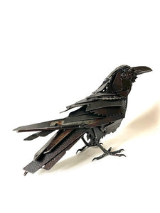 "Ebony" reclaimed metal sculpture by David Groenjes, 12-inch tall raven with layered steel feathers, crafted from salvaged industrial materials.