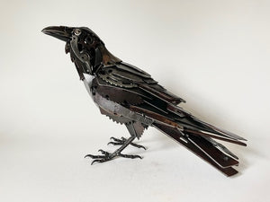 "Ebony" reclaimed metal sculpture by David Groenjes, 12-inch tall raven with layered steel feathers, crafted from salvaged industrial materials.