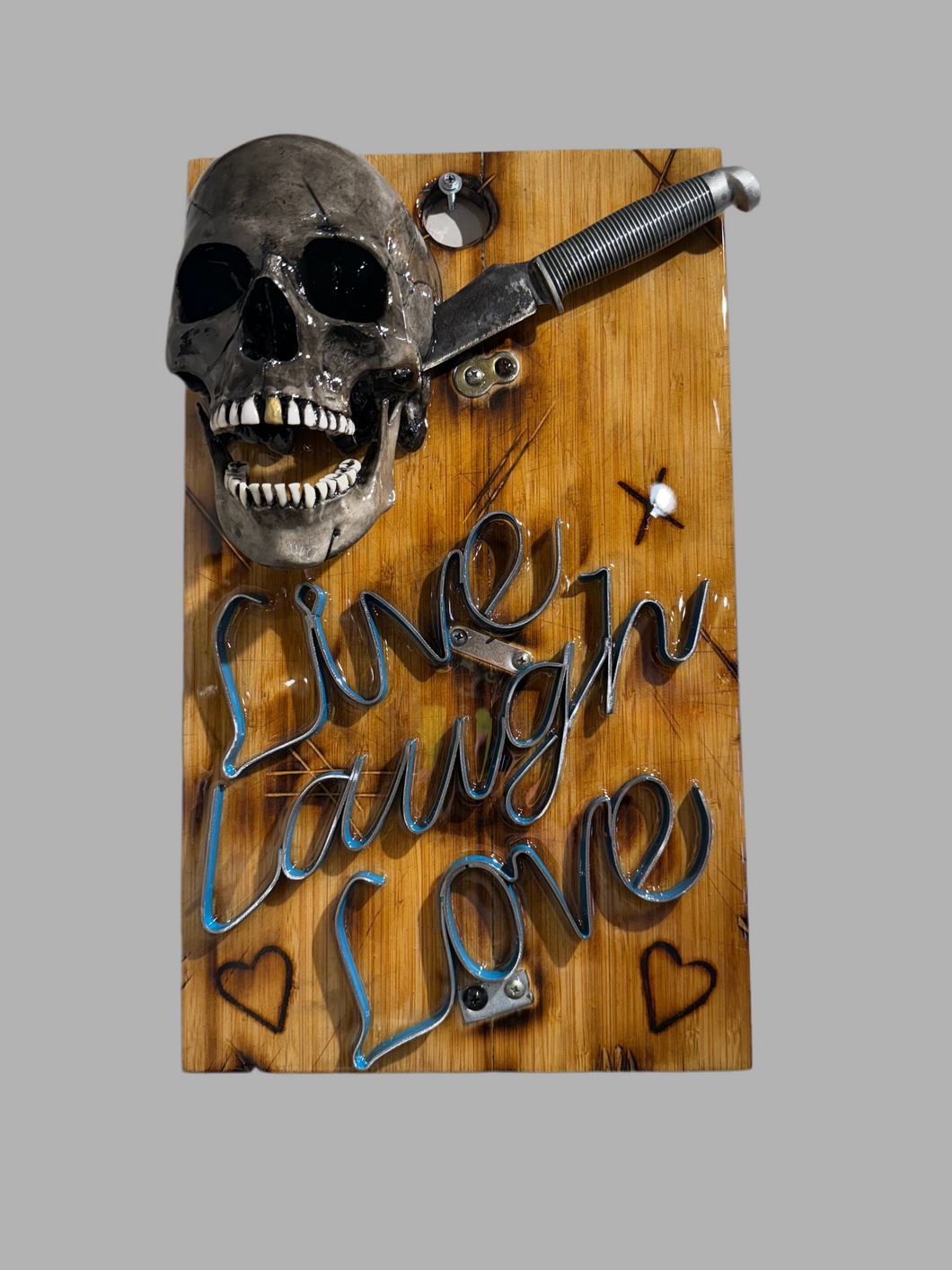 Live, Laugh, Love – A handcrafted steampunk metal skull wall sculpture featuring exposed gears, riveted panels, and integrated lighting, blending industrial aesthetics with vintage mechanical design.