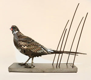 "Losing Ground" – Metal pheasant sculpture by artist David Groenjes, crafted from reclaimed steel and found objects, displayed in an outdoor natural setting