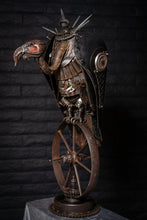 Load image into Gallery viewer, &quot;Lurking Westward&quot; reclaimed metal sculpture by Paul Klaine, vulture-like mechanical bird with spiked armor perched on a single steel wheel, industrial steampunk artwork.