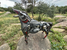 Load image into Gallery viewer, Side view of Howler Deluxe, a metal coyote sculpture blending steampunk mechanics with nature-inspired design