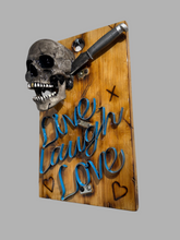 Load image into Gallery viewer, Live, Laugh, Love – A handcrafted steampunk metal skull wall art piece with riveted panels, exposed gears, and built-in industrial lighting