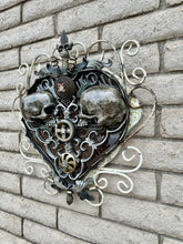 Load image into Gallery viewer, Sprung on You&quot; reclaimed metal wall sculpture by Paul Klaine, 25-inch heart-shaped artwork with opposing skulls, gears, and ornate steel scrollwork