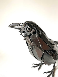 "Ebony" reclaimed metal sculpture by David Groenjes, 12-inch tall raven with layered steel feathers, crafted from salvaged industrial materials.