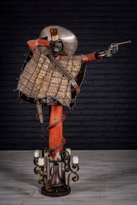 "Shot for Shot" reclaimed metal sculpture by Paul Klaine, 56-inch tall skeletal gunslinger with sombrero, tequila bottle, revolver, and industrial steel base with bell and candles.