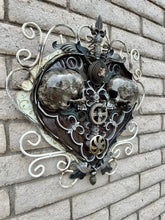 Load image into Gallery viewer, &quot;Sprung on You&quot; reclaimed metal wall sculpture by Paul Klaine, 25-inch heart-shaped artwork with opposing skulls, gears, and ornate steel scrollwork.