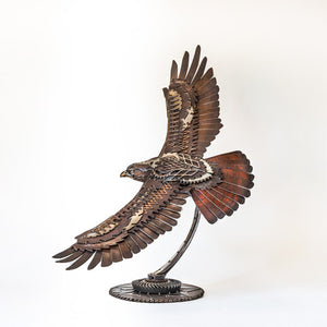 "The Red Baron" reclaimed metal sculpture by David Groenjes, industrial artwork crafted from salvaged steel and mechanical parts, aviation-inspired contemporary sculpture.