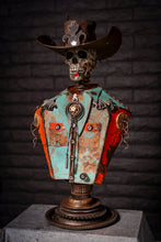 Load image into Gallery viewer, &quot;Let’s Get Western&quot; reclaimed metal sculpture by Paul Klaine, skeletal cowboy bust with wide-brimmed hat, bolo tie, turquoise and orange steel shirt, mounted on gear pedestal.