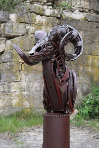 "Cliffhanger" reclaimed metal sculpture by David Groenjes, 69-inch tall bighorn sheep with coiled horns, crafted from salvaged steel and welded industrial parts.